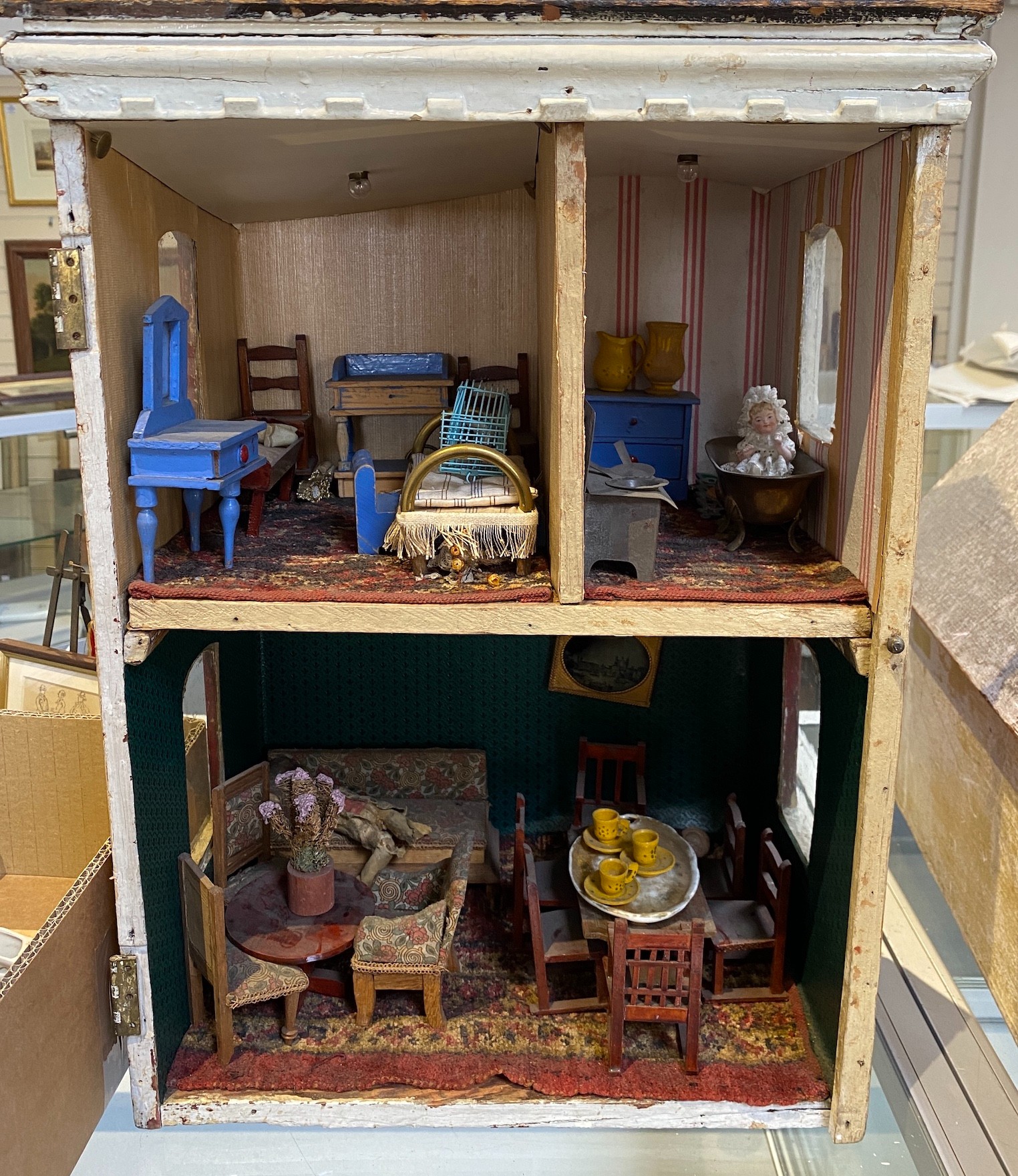 ‘Queens Lynn House’. A late 19th century home-made dolls' house, and contents, 66cm high